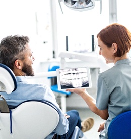 male patient and female dentist discussing bone graft