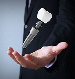 Hand holding an animated dental implant supported dental crown