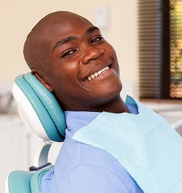 Man smiling in treatment chair