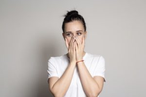 worried woman covering mouth
