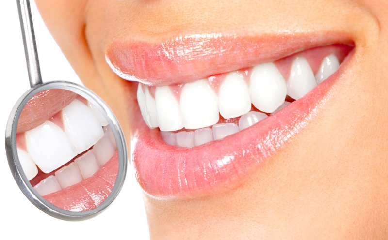 an up-close look at a woman’s teeth and gums after having gum recontouring